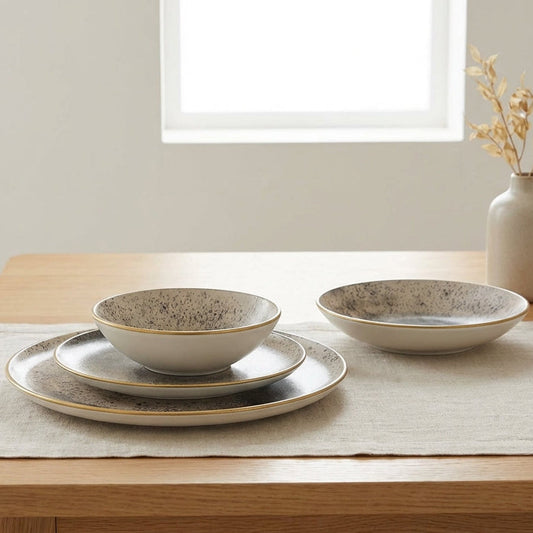 Dining table set with ceramic bowls and plates on a light-colored surface.