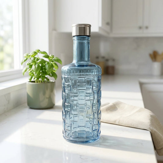 Blue glass bottle with textured design on a kitchen counter