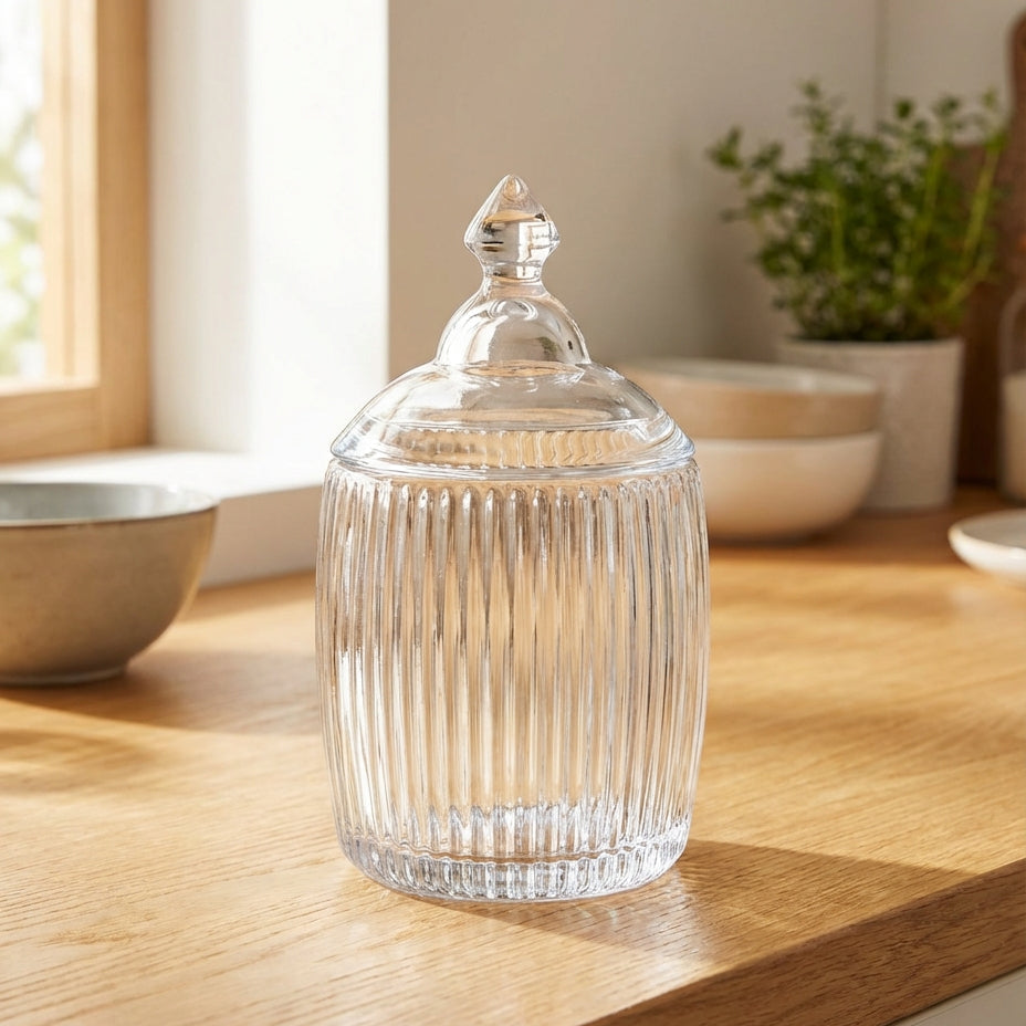 Clear glass jar with ribbed design on a wooden surface