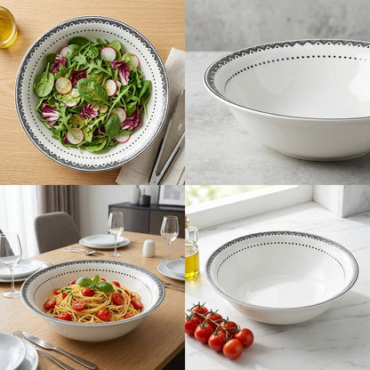 White ceramic bowl with decorative rim containing a salad and pasta, on a wooden table and marble surface.