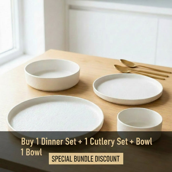 Set of white ceramic dishes on a wooden surface with a neutral background