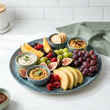 Fruit platter with dips on a white surface