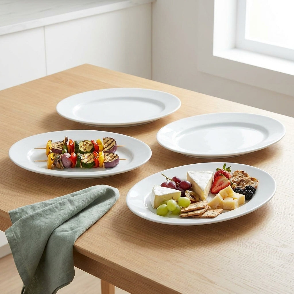 Three white plates with food on a wooden table, including skewers and a cheese platter.