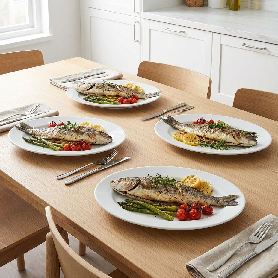 Dinner table set with plates of fish and vegetables in a kitchen.