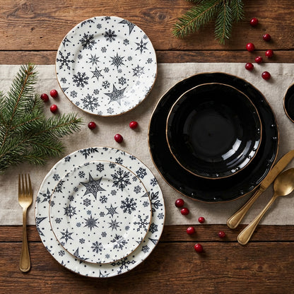 Dinnerware set with snowflake patterns on a wooden table with Christmas decorations.