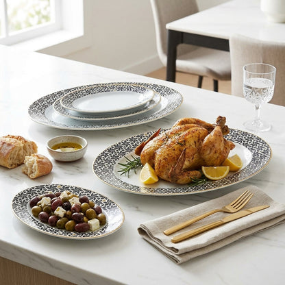 Dinner table set with roasted chicken, olives, bread, and a glass of water.