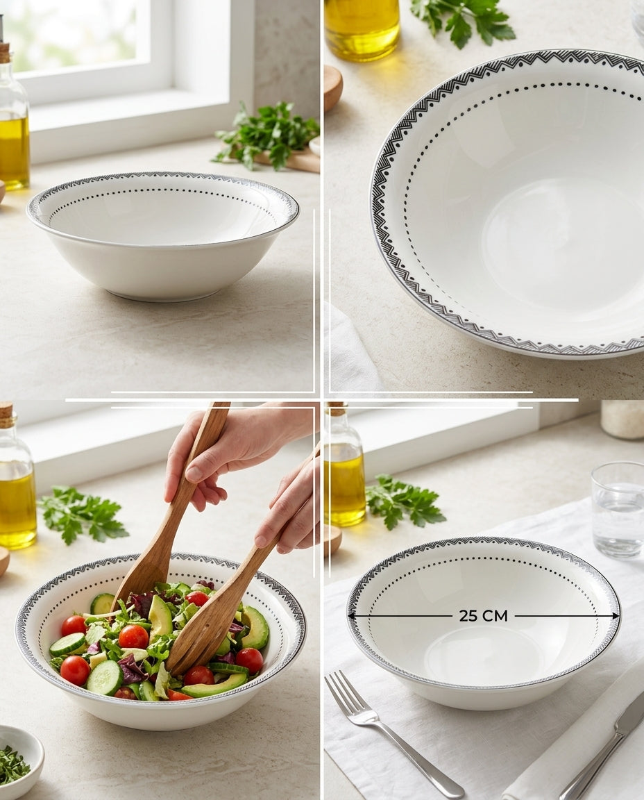 White ceramic bowl with decorative rim on a light wooden surface, containing salad and measuring 25 cm.