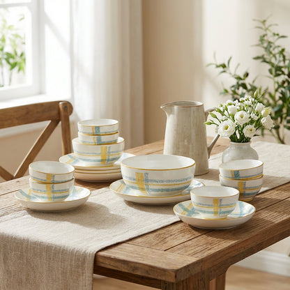 Dinnerware set with plaid patterns on a wooden table with a neutral background
