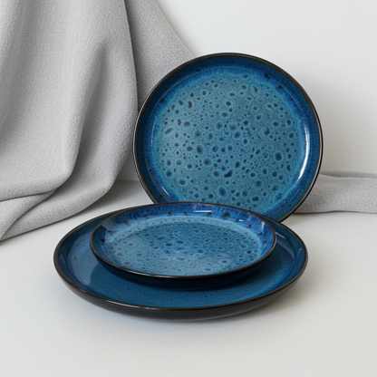 Set of blue ceramic plates with textured surface on a light gray background