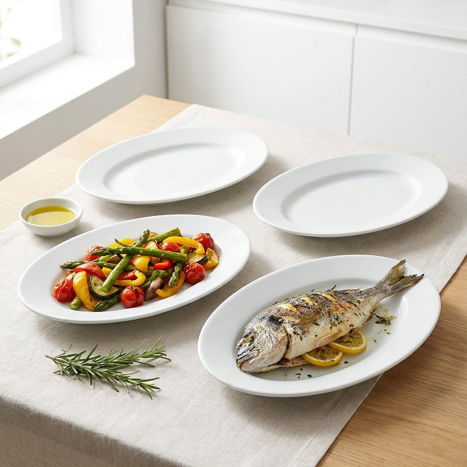 Set of white ceramic plates on a table with food and olive oil.