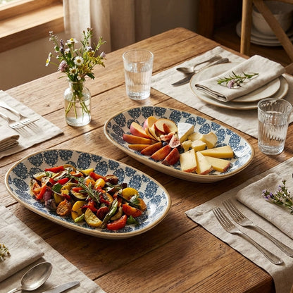 Dining table set with plates of food, glasses, and cutlery in a home setting.