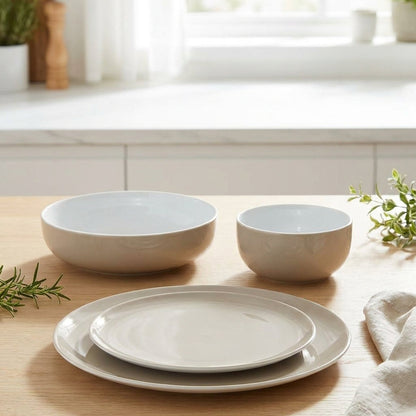 Set of ceramic dishes on a wooden table with a kitchen background
