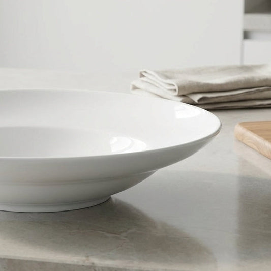 White ceramic bowl on a marble countertop with a neutral background
