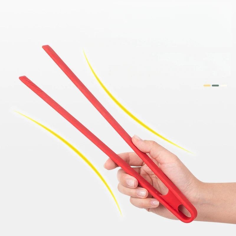 Red plastic tool held by a hand on a white background