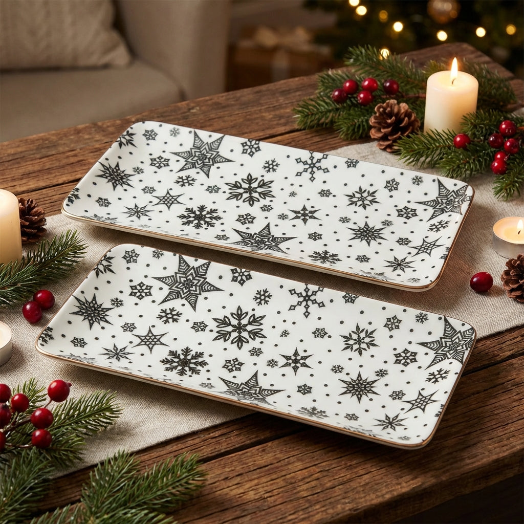 Two decorative trays with snowflake patterns on a festive table with candles and Christmas decor.