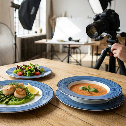 Person taking photos of a meal setup with a camera on a tripod.