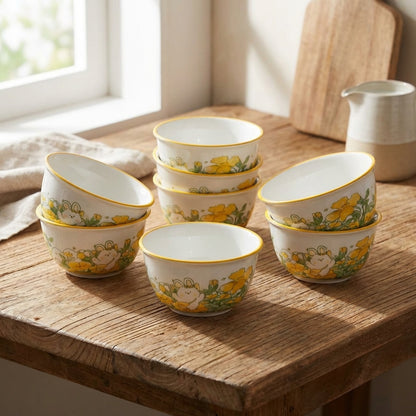 Set of ceramic bowls with floral patterns on a wooden surface