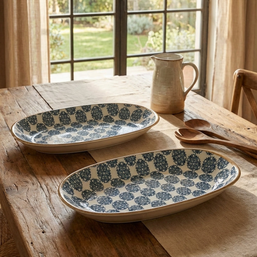 Two ceramic serving dishes with blue floral patterns on a wooden table.