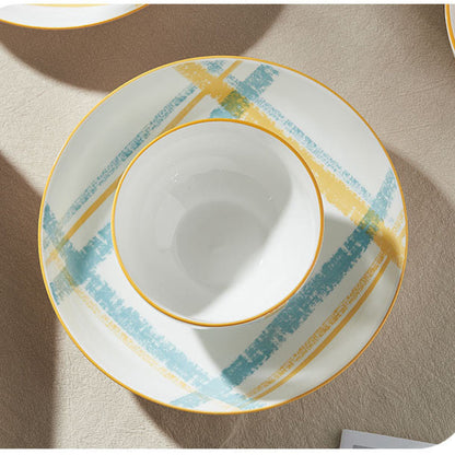 Ceramic dish with gold rim on a beige surface, featuring text in Chinese.